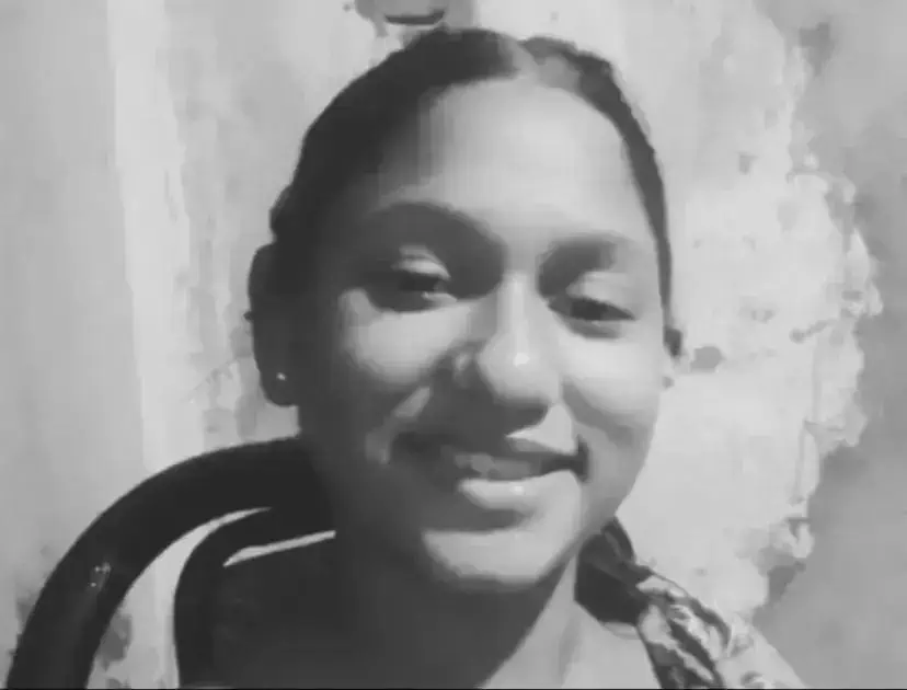 Menina sorridente com mochila, retrato em preto e branco, assunto relevante para notícias de direitos humanos, educação e inclusão social.