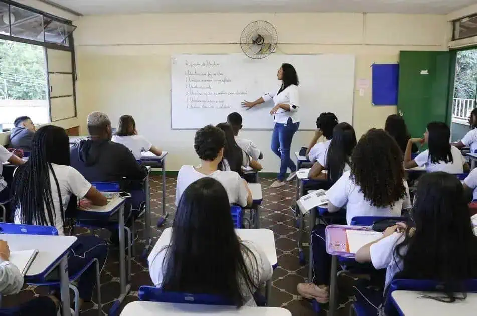 Professora ensinando uma turma de estudantes em sala de aula, ambiente acadêmico de ensino de Direito, foco em educação jurídica e aprendizagem.
