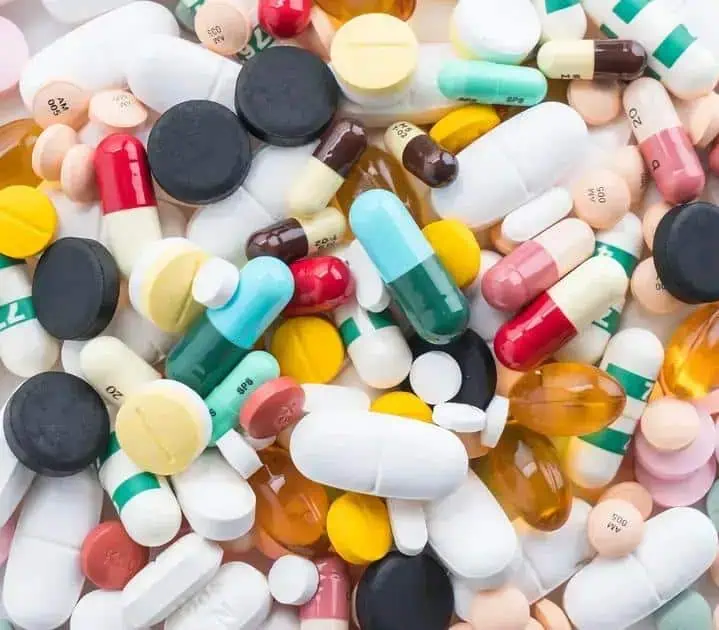 Remédios e medicamentos variados em pilulas e cápsulas, representando temas de saúde e legislação farmacêutica.