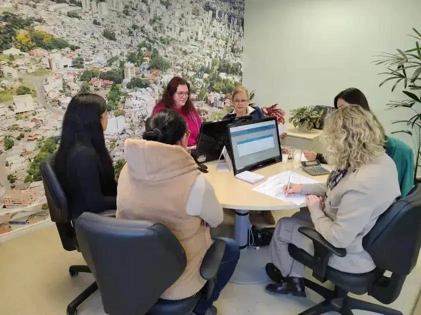 Advocacy meeting with women discussing legal issues in a modern office setting.