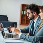 Profissionais do Direito participando de reunião de trabalho com tecnologia e inovação em escritório de advocacia.