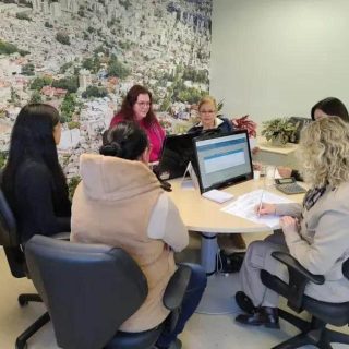 Advocacy meeting with women discussing legal issues in a modern office setting.