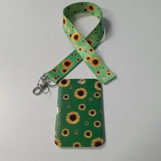 Luva de celular com estampa de girassóis e fita de identificação, ideal para proteção e organização em ambientes jurídicos e notícias sobre direito.