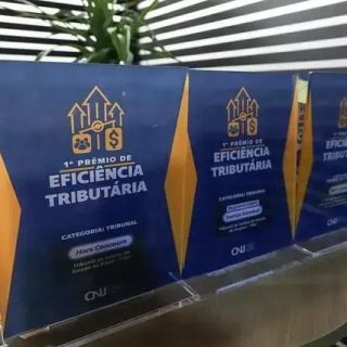 Prêmios de reconhecimento na área de eficiência tributária expostos em cerimônia de premiação, destacando sucesso no setor jurídico e fiscal.
