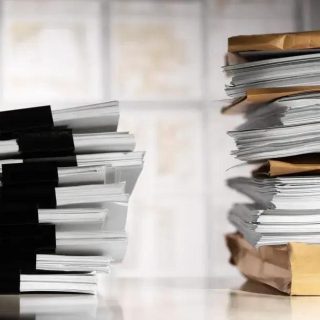 Pilhas de documentos e processos jurídicos, representação do trabalho jurídico, direito e legislação, foco em notícias de direito.